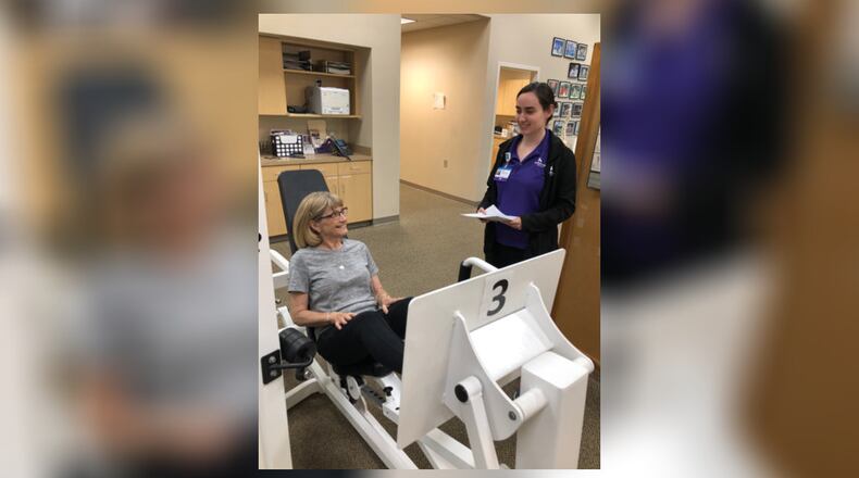 Physical therapist Julia Ward works with Sandy Stremel of Centerville. CONTRIBUTED