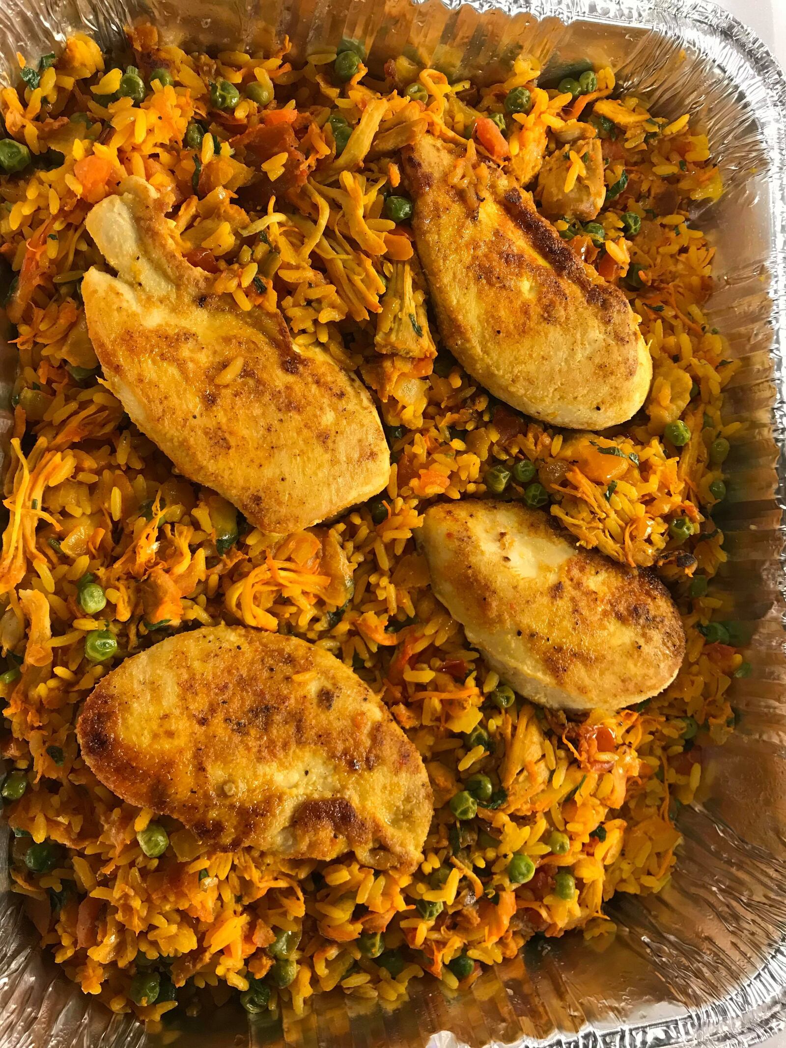 El Meson is among the restaurants offering carryout and curbside serve.  Arroz Con Pollo is pictured.
