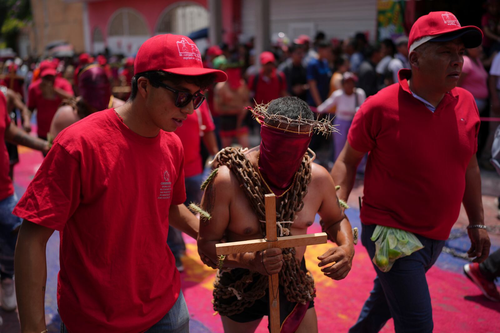 A masked penitent in chains with cacti attached to his arms, marches in a Holy Week procession in Atlixco, Mexico, on Good Friday, April 18, 2025. (AP Photo/Eduardo Verdugo)