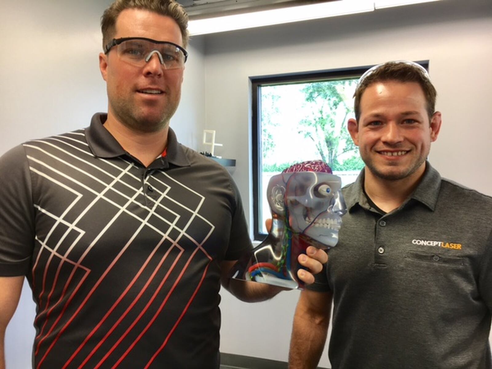 Adam Clark, left, CEO of Fairborn’s Tangible Solutions, and Chris Collins, the company’s chief operating officer. Their small company is part of what they believe is a new “industrial revolution.” THOMAS GNAU/STAFF