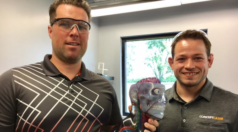 Adam Clark, left, CEO of Fairborn’s Tangible Solutions, and Chris Collins, the company’s chief operating officer. Their small company is part of what they believe is a new “industrial revolution.” THOMAS GNAU/STAFF