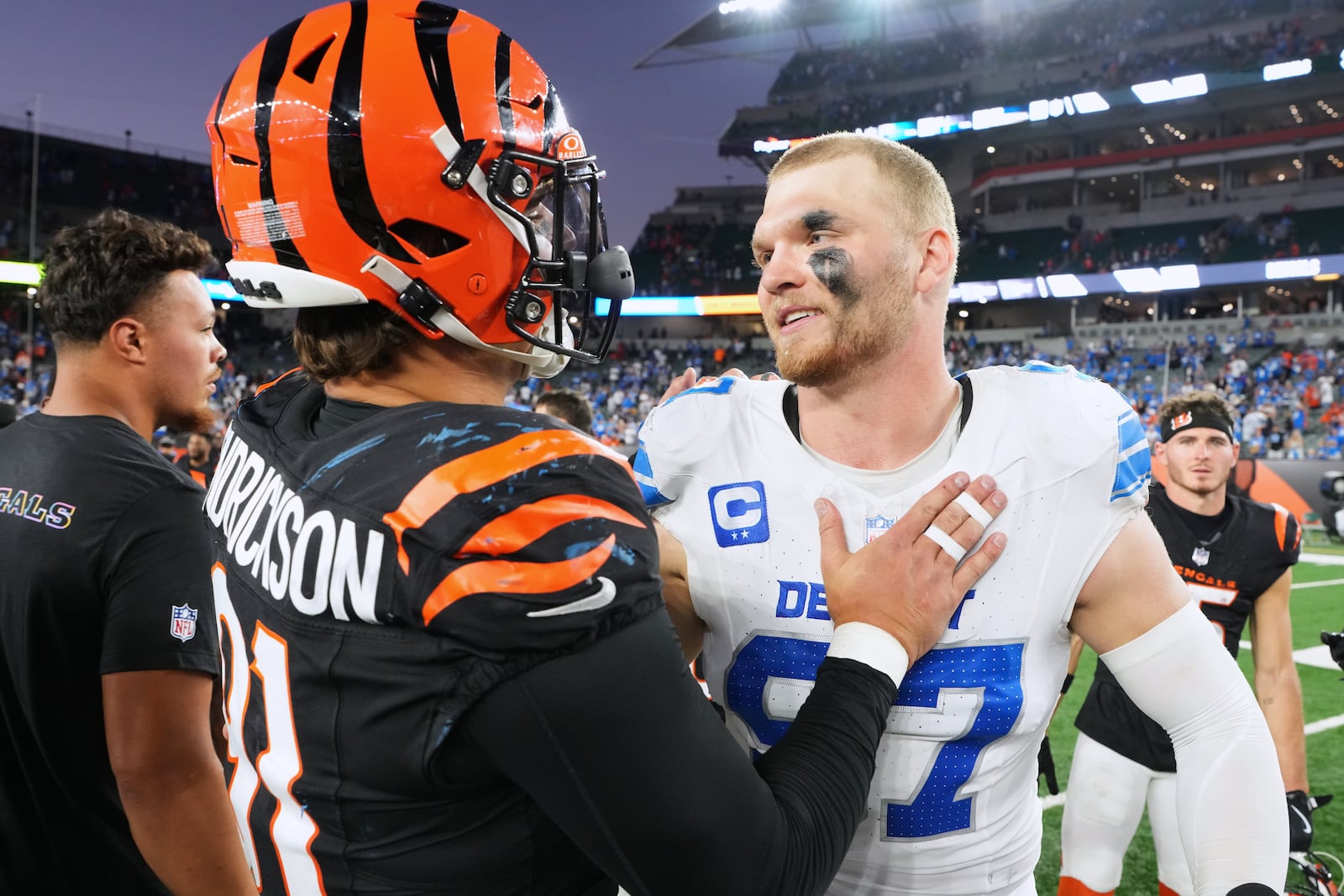 Cincinnati Bengals defensive end Trey Hendrickson (91) and Detroit Lions defensive end Aidan Hutchinson (97) talk after an NFL football game Sunday, Oct. 5, 2025, in Cincinnati. (AP Photo/Jeff Dean)
