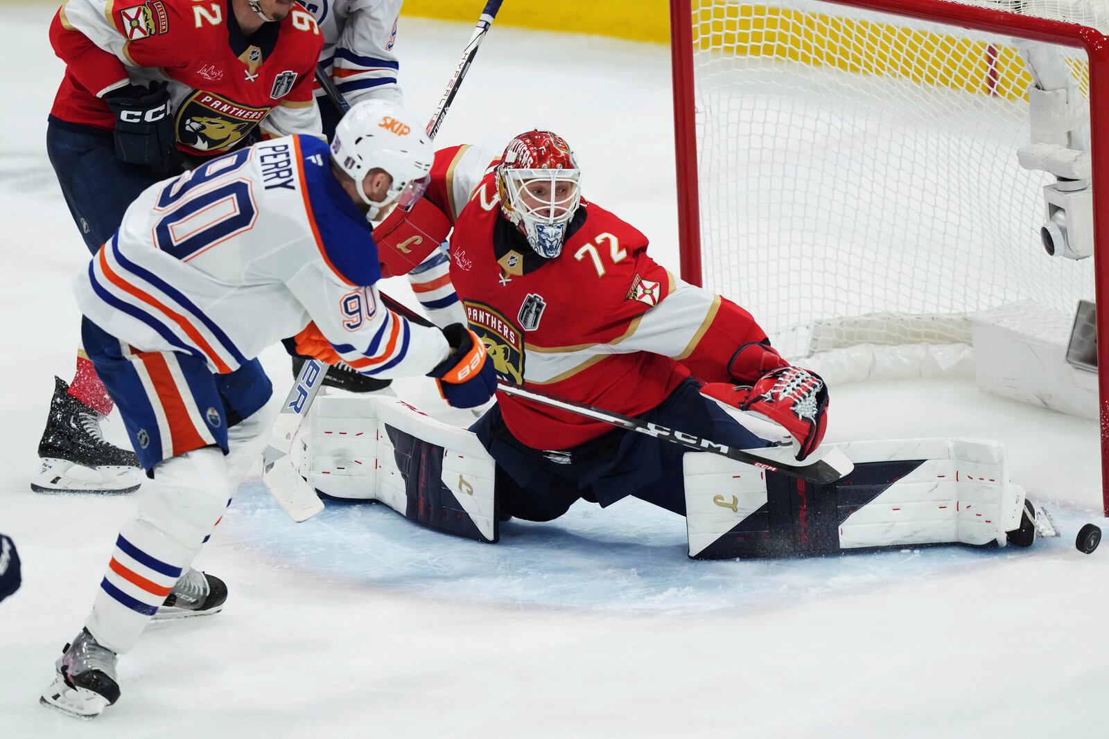 Edmonton Oilers' Corey Perry (90) is stopped by Florida Panthers goalie Sergei Bobrovsky (72) during the third period in Game 4 of the NHL hockey Stanley Cup Final in Sunrise, Fla., Thursday, June 12, 2025. (Nathan Denette/The Canadian Press via AP)