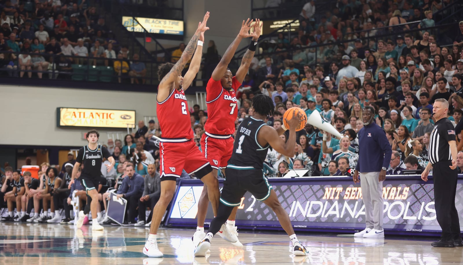 Dayton's De'Shayne Montgomery, left, and Keonte Jones apply pressure against North Carolina Wilmington in the first round of the National Invitation Tournament on Saturday, March 21, 2026, at Trask Coliseum in Wilmington, N.C.. David Jablonski/Staff