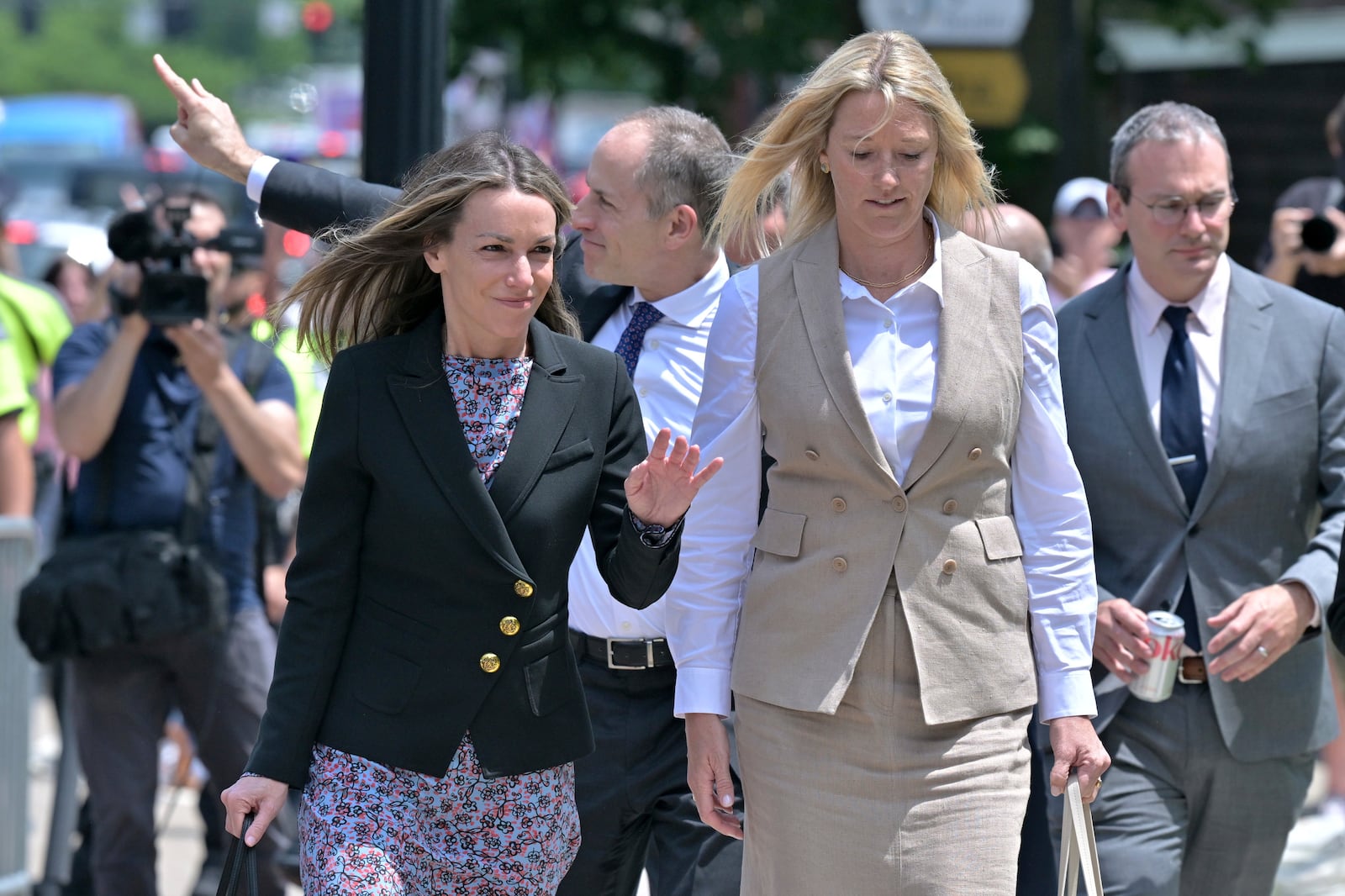 Karen Read, left, and her lawyer David Yanetti, second from left, acknowledge supporters as they return to the Dedham, Mass. courthouse, where the judge was to issue instructions to the jury in Read's trial at Norfolk Superior Court, Friday, June 13, 2025, in Dedham, Mass. (AP Photo/Josh Reynolds)