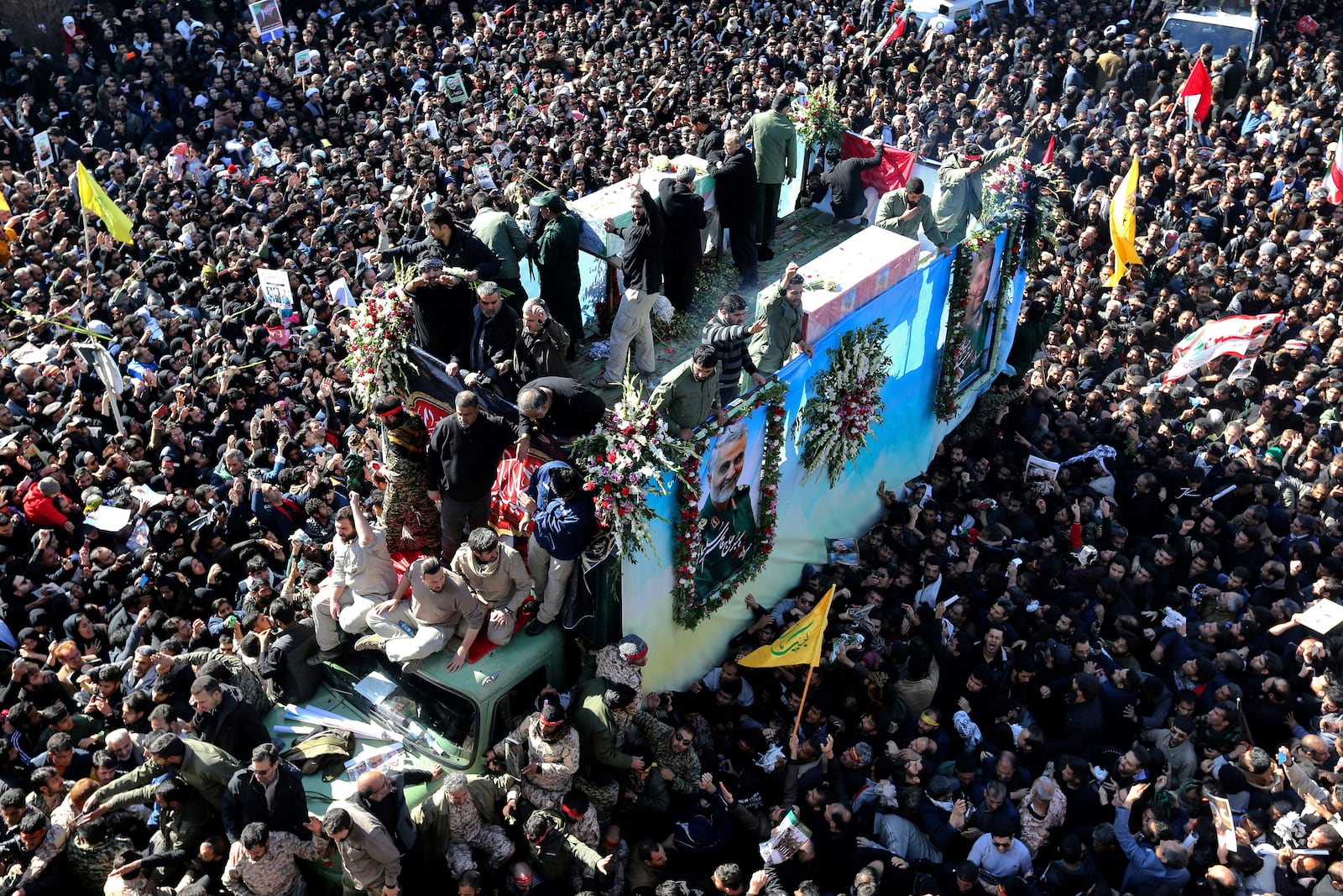 FILE - Coffins of Gen. Qassem Soleimani and others who were killed in Iraq by a U.S. drone strike, are carried on a truck surrounded by mourners during a funeral procession, in the city of Kerman, Iran, Jan. 7, 2020. (AP Photo, File)