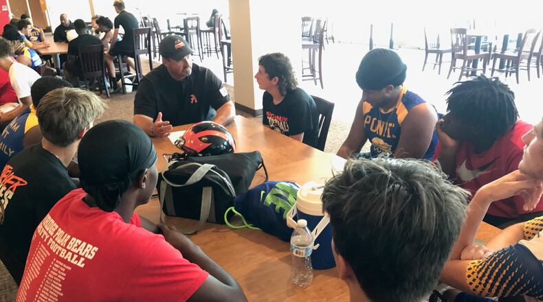 One of the round table Social Justice 7 on 7 round table discussions – this one led by new Arcanum head coach and former Dayton Flyers football player Matt Macy – that included a racial mix of two players each from four different high school teams and one or two coaches at each table. In all 40 schools that included 1,400 athletes and 200 coaches from the Miami Valley, Cincinnati, Hamilton, Middletown, Springfield, Columbus, Lima and Detroit took part in what was two hours of football and an hour of talk for each team. (Photo by Tom Archdeacon)