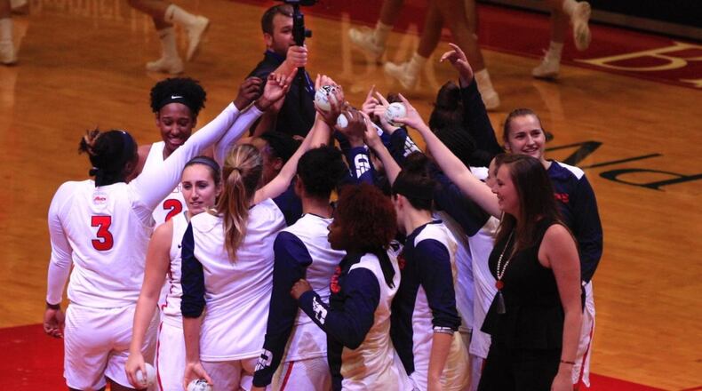 The Dayton women’s basketball team huddles before a game in 2018 at UD Arena. David Jablonski/Staff