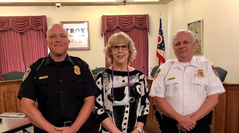 Left to right: Newly promoted Troy Police Captain Ryan T. Ormberg, Troy Mayor Robin Oda, and newly promoted Troy Police Chief Shawn O. McKinney