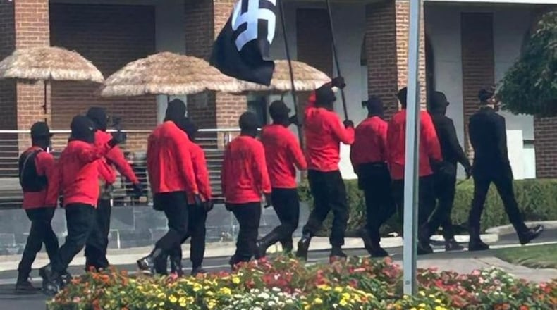 12 people carrying swastika flags and rifles while wearing ski masks walked around downtown Springfield during the Jazz & Blues Fest on Saturday, Aug. 10, 2024. Contributed