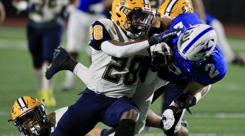 Springfield's Jaivian Norman makes a tackle against St. Xavier in a Division I state semifinal on Friday, Nov. 6, 2020, at Alexander Stadium in Piqua. David Jablonski/Staff