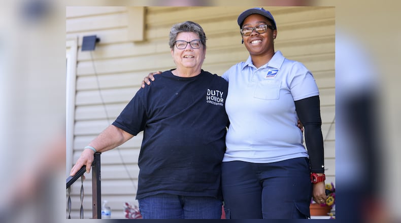 Dawnisha “Dee” Thompson-Newsome (right) has been named a Dayton Daily News Community Gem for her work as a mail carrier in Kettering. Last July she was delivering mail when one of the women on her route, Carla Nelson (left), fell on her front steps. BRYANT BILLING / STAFF