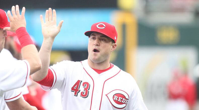 The Reds’ Scott Schebler is introduced on Opening Day on March 30, 2018, at Great American Ball Park in Cincinnati. David Jablonski/Staff