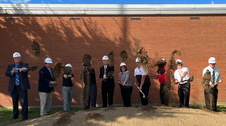 Stakeholders for the Wayne High School career technology expansion project, including Superintendent Jason Enix, center, broke ground Thursday. AIMEE HANCOCK / STAFF