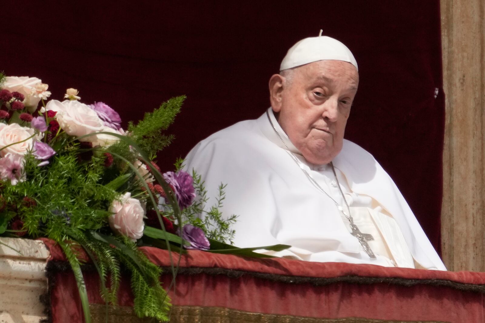 Pope Francis appears on the central lodge of St. Peter's Basilica to bestow the Urbi et Orbi (Latin for to the city and to the world) blessing at the end of the Easter mass presided over by Cardinal Angelo Comastri in St. Peter's Square at the Vatican Sunday, April 20, 2025. (AP Photo/Gregorio Borgia)