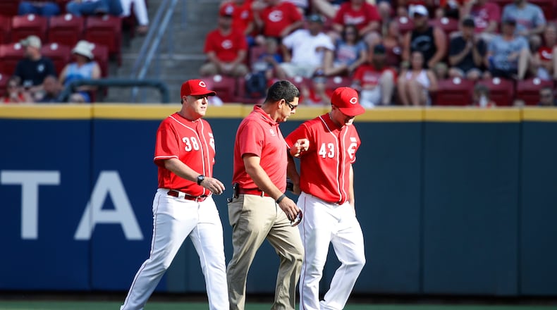 CINCINNATI, OH - JUNE 03: Scott Schebler #43 of the Cincinnati Reds leaves the game after being injured making a diving catch in right field in the sixth inning of a game against the Atlanta Braves at Great American Ball Park on June 3, 2017 in Cincinnati, Ohio. The Braves defeated the Reds 6-5 in 12 innings. (Photo by Joe Robbins/Getty Images)