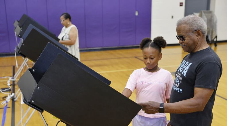 Harry and Lois Truss brought their great granddaughter, Maddisyn Davis, 10, with them to teach her about voting with Issue 1 on the ballot Tuesday, Aug. 8, 2023 at Rosa Parks Elementary School in Middletown. NICK GRAHAM/STAFF