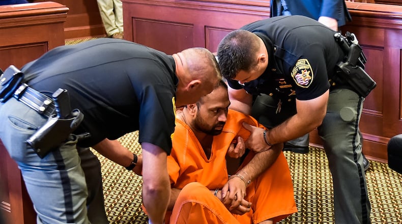Gurpreet Singh, the West Chester man facing 4 counts of capital murder for the shooting death of 4 family members, was arraigned in Butler County Common Pleas Court Monday, August 5 in Hamilton. Singh fell to the ground while standing at the podium during the arraignment and was help up by Butler County Sheriff’s deputies. NICK GRAHAM/STAFF