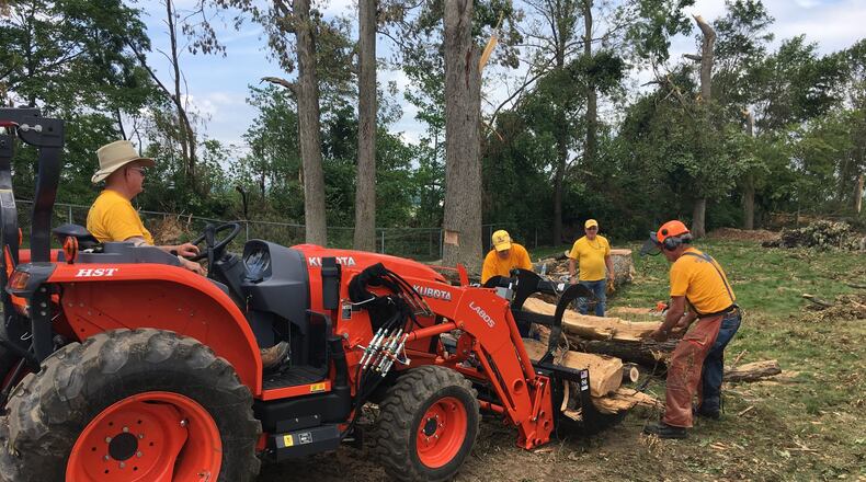Members of the national organization Southern Baptist Disaster Relief help remove trees and debris from a backyard on Rushton Drive Wednesday June 5, 2019. RICHARD WILSON/STAFF