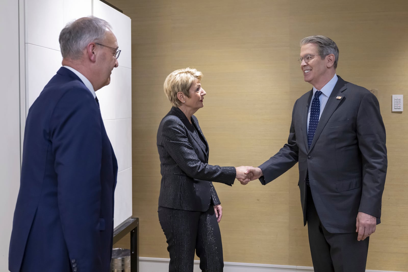 US Secretary of the Treasury Scott Bessent, right, shakes hands with Switzerland's President Karin Keller-Sutter, center, next to Switzerland's Economy Minister Federal Councillor Guy Parmelin, left, during a bilateral meeting between Switzerland and the United States, in Geneva, Switzerland, on Friday, May 9, 2025. (Martial Trezzini/Keystone via AP)