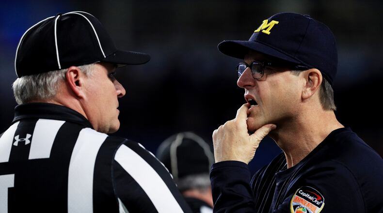 MIAMI GARDENS, FL - DECEMBER 30: Head coach Jim Harbaugh of the Michigan Wolverines talks to a referee in the first half against the Florida State Seminoles during the Capitol One Orange Bowl at Sun Life Stadium on December 30, 2016 in Miami Gardens, Florida. (Photo by Mike Ehrmann/Getty Images)