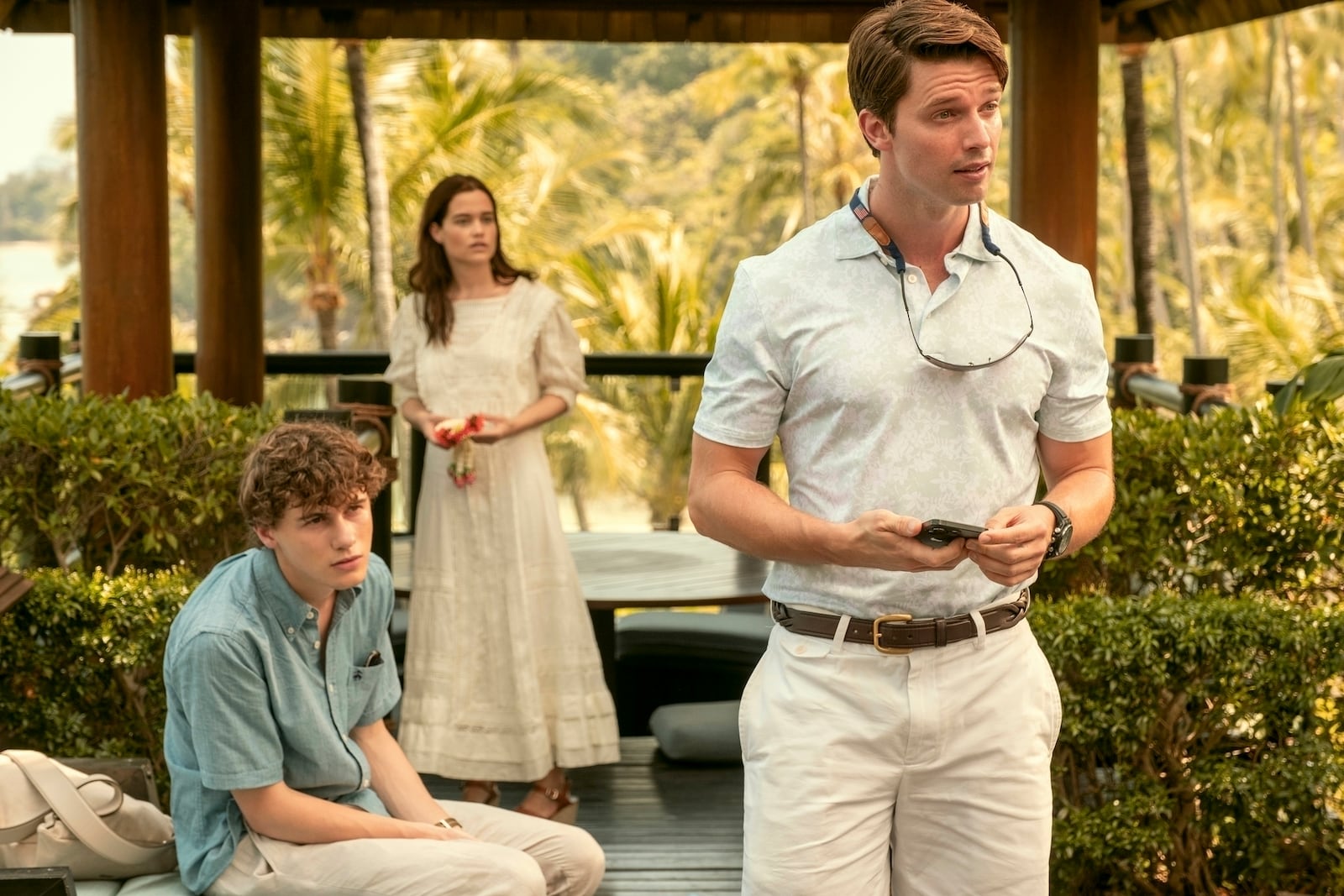 This image released by HBO shows Sam Nivola, from left, Sarah Catherine Hook, and Patrick Schwarzenegger in a scene from "The White Lotus." (Fabio Lovino/HBO via AP)