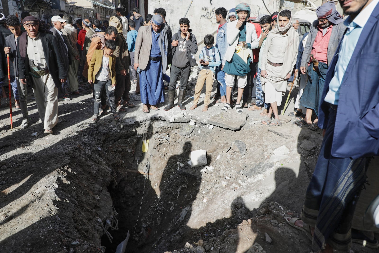 Yemenis watch a crater of an explosion at Farwah popular market which Houthis said it was struck by U.S. airstrikes in Sanaa, Yemen, Monday, April 21, 2025. (AP Photo)