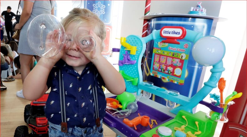 In this 2018 photo Hutton, 3, plays with Little Tikes Circuit Center at the Walmart Toy Shop event in New York. The Ohio-based company is celebrating its 50th anniversary. (AP Photo/Richard Drew)