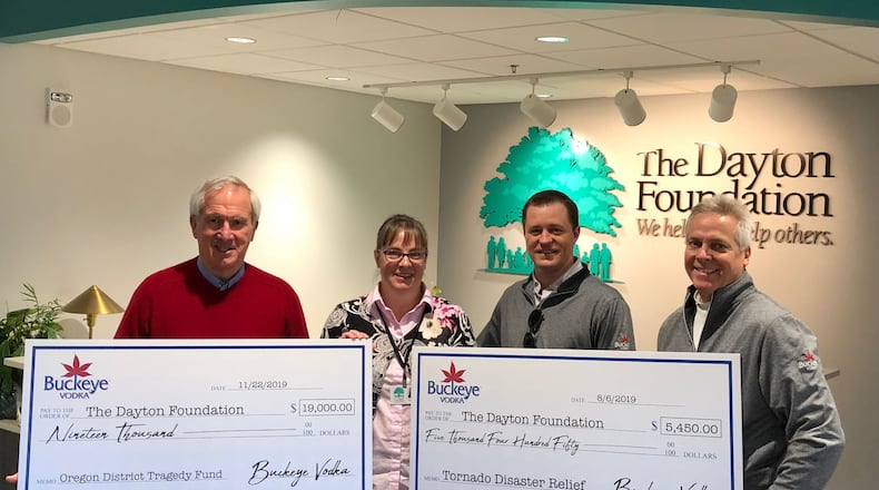 Buckeye Vodka let a fund-raising effort that raised $19,000 for Oregon District shooting victims and $5,450 for tornado relief. From left to right are Tom Rambasek, president of Buckeye Vodka; Carrie Dalrymple of the Dayton Foundation; Charlie Ballinger, Buckeye Vodka Southern Ohio Regional Manager; and Jim Finke, CEO of Buckeye Vodka.
