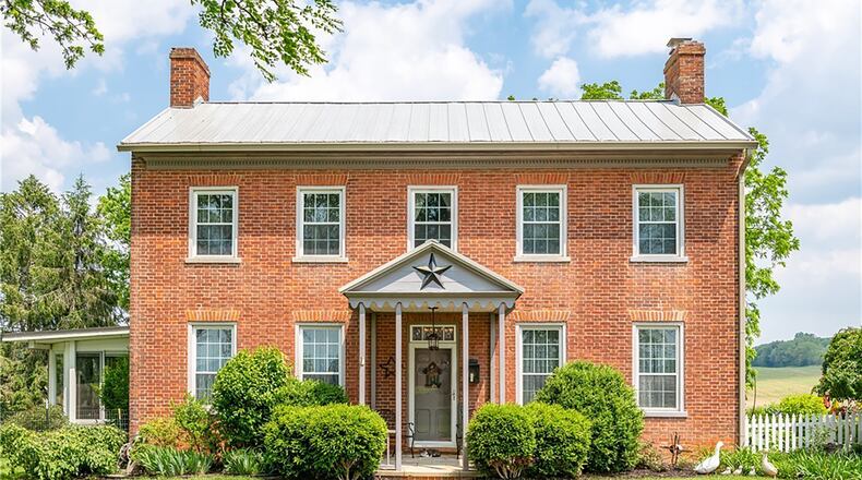 This historic brick farmhouse was bult in 1830 and has been updated to include a detached two car garage, inground pool with pool house and addition. CONTRIBUTED