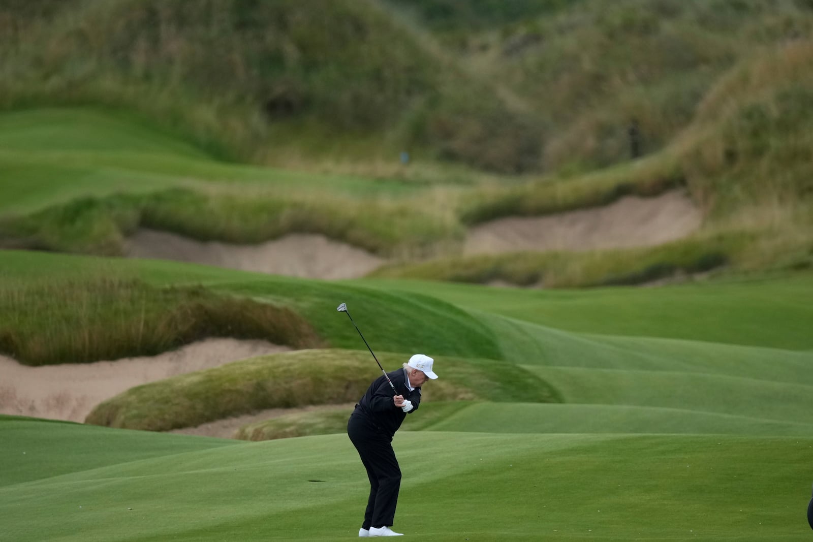 President Donald Trump plays golf after attending the opening ceremony for Trump International Golf Links near Aberdeen, Scotland Tuesday, July 29, 2025.(AP Photo/Alastair Grant)