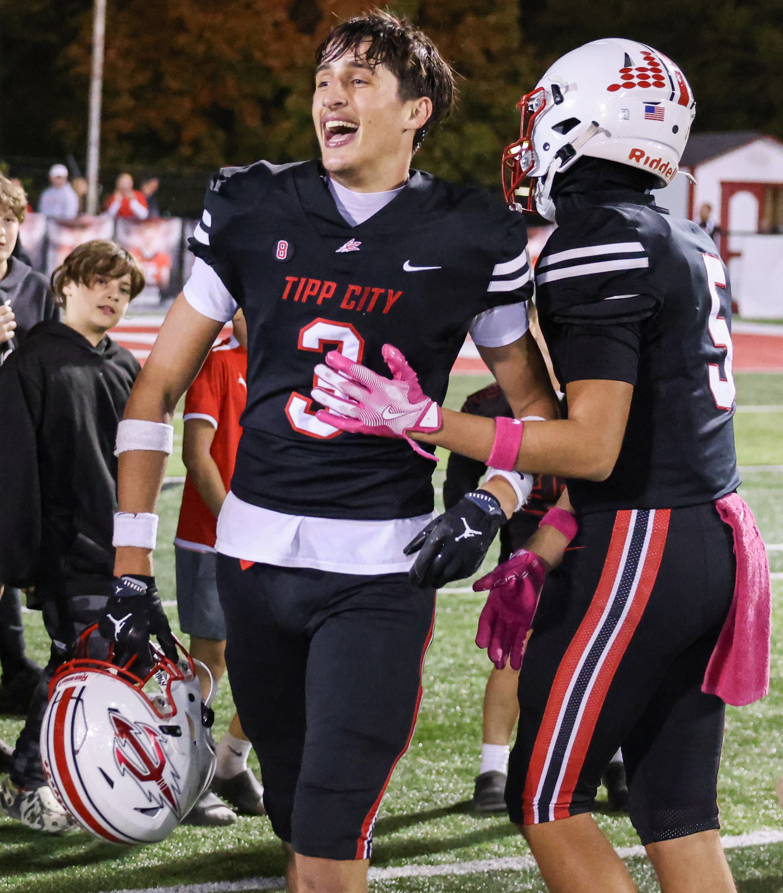 Tippecanoe senior receiver Atticus Poulos (right) celebrates with senior receiver Daniel Button after the Red Devils beat Troy 21-0 in a Miami Valley League game on Friday, Oct. 17 at Tipp City Park. BRYANT BILLING / STAFF