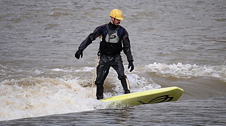 Chris Romie, enjoys river surfing on the Great Miami River near downtown Dayton on Friday, March 24, 2017. Making the Great Miami Riverway a top place to visit in Ohio was a topic of discussion at the 10th Annual River Summit at the University of Dayton on Friday. Staff Photo/Marshall Gorby