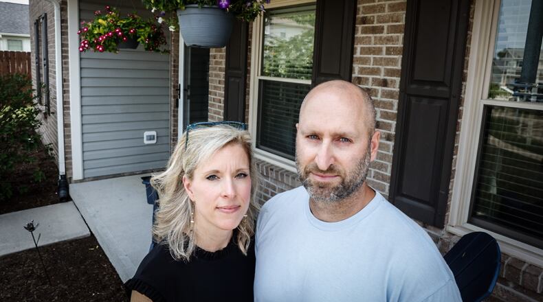 Tara and Ken Folino moved from Oakwood earlier this year after purchasing a home in Brookville for one-and-a-half times more than their household income. They plan to build a new home in Brookville which will cost them 30% more than they originally planned, raising the overall cost from four times their household income to more than five times that amount. JIM NOELKER/STAFF