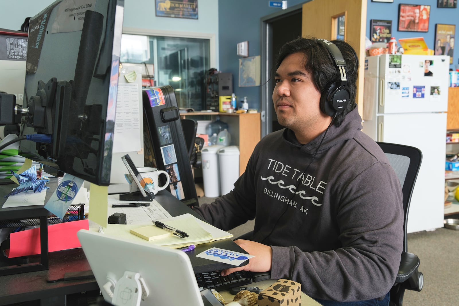 This photo provided by Brian Venua shows Venua, a reporter at the public radio station KMXT, on air, Thursday, July 17, 2025, in Kodiak, Alaska. (Brian Venua via AP)