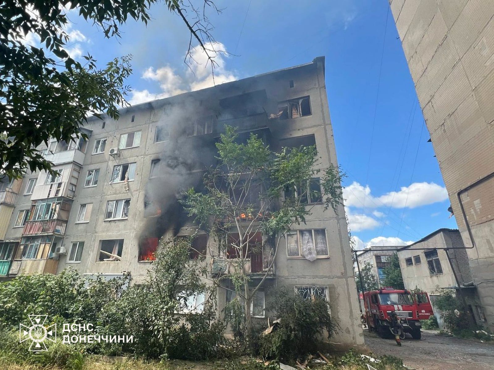 In this photo provided by the Ukrainian Emergency Service, emergency services personnel work to extinguish a fire following a Russian attack in Donetsk region, Ukraine, Wednesday, July 2, 2025. (Ukrainian Emergency Service via AP)