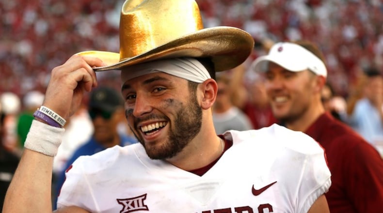 Oklahoma quarterback Baker Mayfield (6) celebrates with the Golden Hat Trophy following the team's win over Texas in an NCAA college football game Saturday, Oct. 14, 2017, in Dallas, Texas. Oklahoma won 29-24. (AP Photo/Ron Jenkins)
