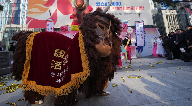 Dancers in a bull-shaped costume perform to celebrate the opening for the 2026 trading year outside of the Korea Exchange in Seoul, South Korea, Friday, Jan. 2, 2026. (AP Photo/Lee Jin-man)