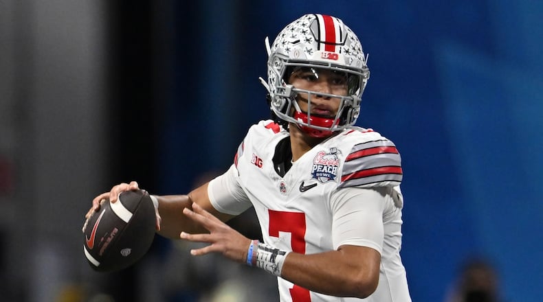 FILE - Ohio State quarterback C.J. Stroud (7) passes against Georgia during the first half of the Peach Bowl NCAA college football semifinal playoff game, Saturday, Dec. 31, 2022, in Atlanta. The Panthers have traded up to acquire the No. 1 overall pick in the draft from the Chicago Bears in exchange for Carolina's No. 9 and No. 61 overall picks in 2023, a first-round pick in 2024, a second-round pick in 2025 and star wide receiver D.J. Moore, two people familiar with the deal said Friday, March 10, 2023, The people spoke to The Associated Press on condition of anonymity because the trade had not been announced. The move allows the Panthers to acquire a potential franchise quarterback, although it remains unclear which player the team prefers. (AP Photo/Danny Karnik, File)