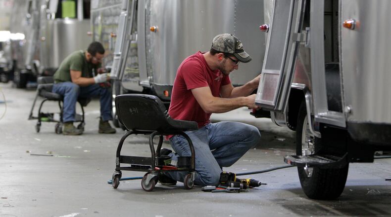 Jackson Center-based Airstream, a manufacturer of recreational vehicles or RVs, and Tommy Bahama, an “island-inspired lifestyle brand,” are partnering to create new RVs. In this 2014 photo, Jordan Peterson, of Bellefontaine, works on an Airstream travel trailer at the Airstream factory in Jackson Center, Ohio. (AP Photo/Jay LaPrete, File)