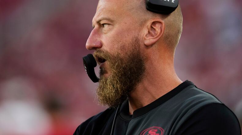 FILE - San Francisco 49ers run game coordinator/tight ends coach Brian Fleury, now offensive coordinator for the Seattle Seahawks, watches from the sideline during the second half of an NFL preseason football game against the Los Angeles Chargers, Aug. 23, 2025, in Santa Clara, Calif. (AP Photo/Godofredo A. Vásquez, File)