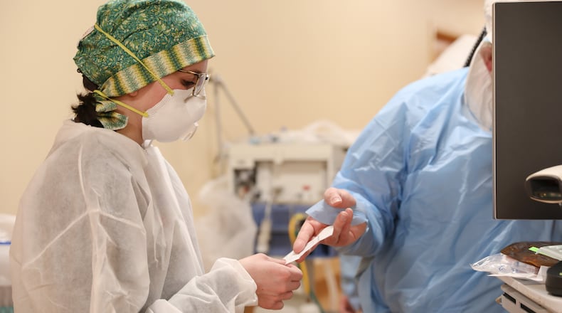 A nurse at Grandview Medical Center prepares to go into the room of a patient that had COVID-19. CONTRIBUTED