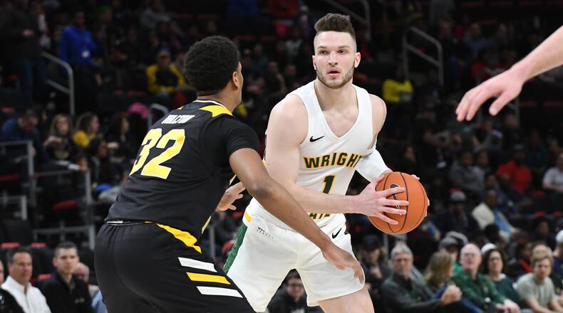 Wright State’s Bill Wampler is defended by Northern Kentucky’s Dantez Walton during the Horizon League tournament championship game in 2018. Wampler scored 27 points in the Raiders’ win over Weber Stateon Monday. Keith Cole/FILE