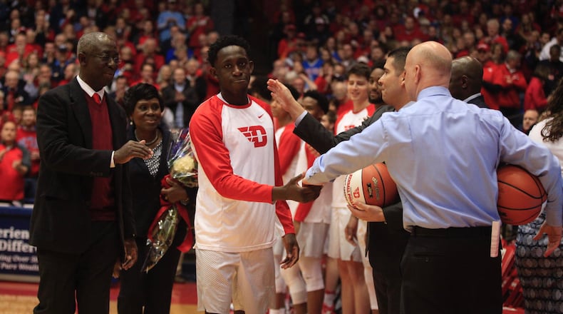 Dayton's Jeremiah Bonsu is honored on Senior Night with his parents on March 1, 2017, at UD Arena.