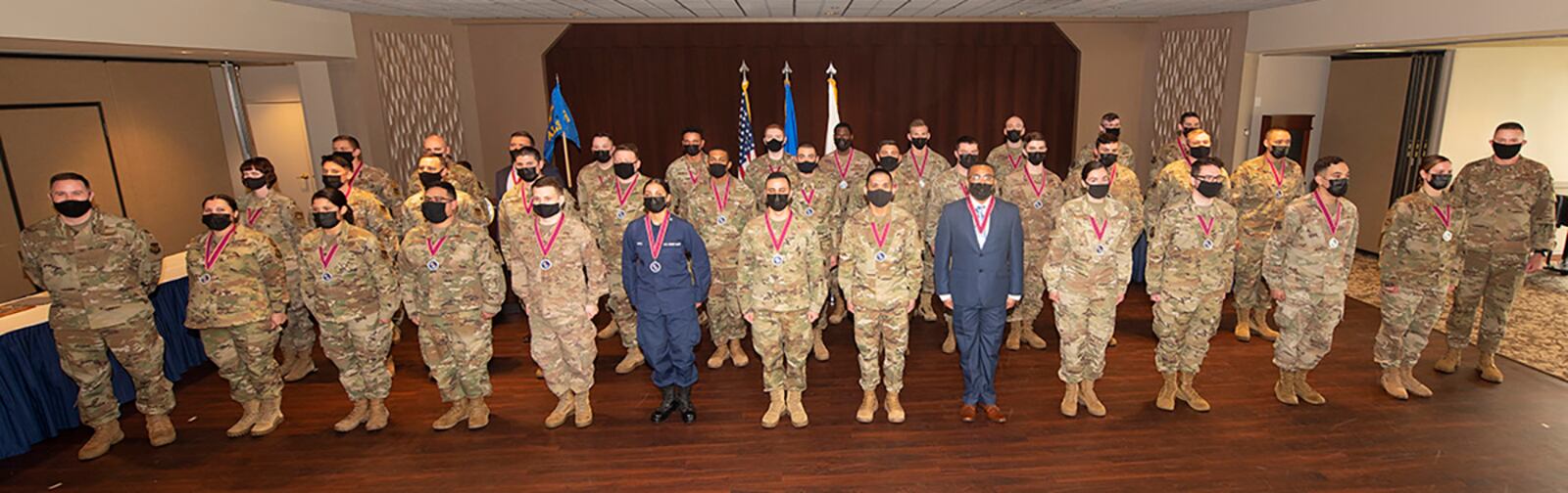 The Airman Leadership School Class 21-D poses with Col. Michael Phillips, 88th Air Base Wing vice commander, and Chief Master Sgt. Jason Shaffer, 88 ABW command chief, at their graduation May 6 at the Wright-Patterson Club. U.S. AIR FORCE PHOTO/R.J. ORIEZ