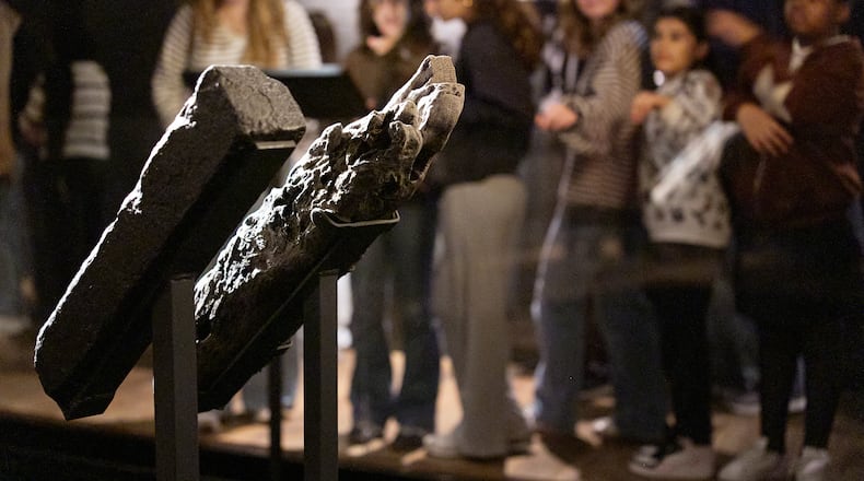School children visit the National Museum of African American History and Culture's Middle Passage exhibit, behind a wooden timber, the artifact at right, from the slave ship, the São José-Paquete de Africa, Friday, March 6, 2026, in Washington. (AP Photo/Jacquelyn Martin)