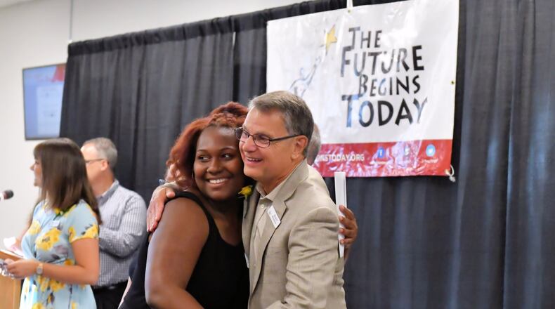 Former Troy schools administrator Alan Zunke congratulates last dollar grant recipient Alaura Holycross during The Future Begins Today recognition program earlier this month at Hobart Arena in Troy. CONTRIBUTED
