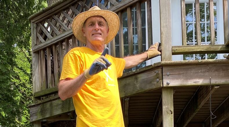 Mike Fanelli stands on all the trash him and his wife have produced in the past year and a half