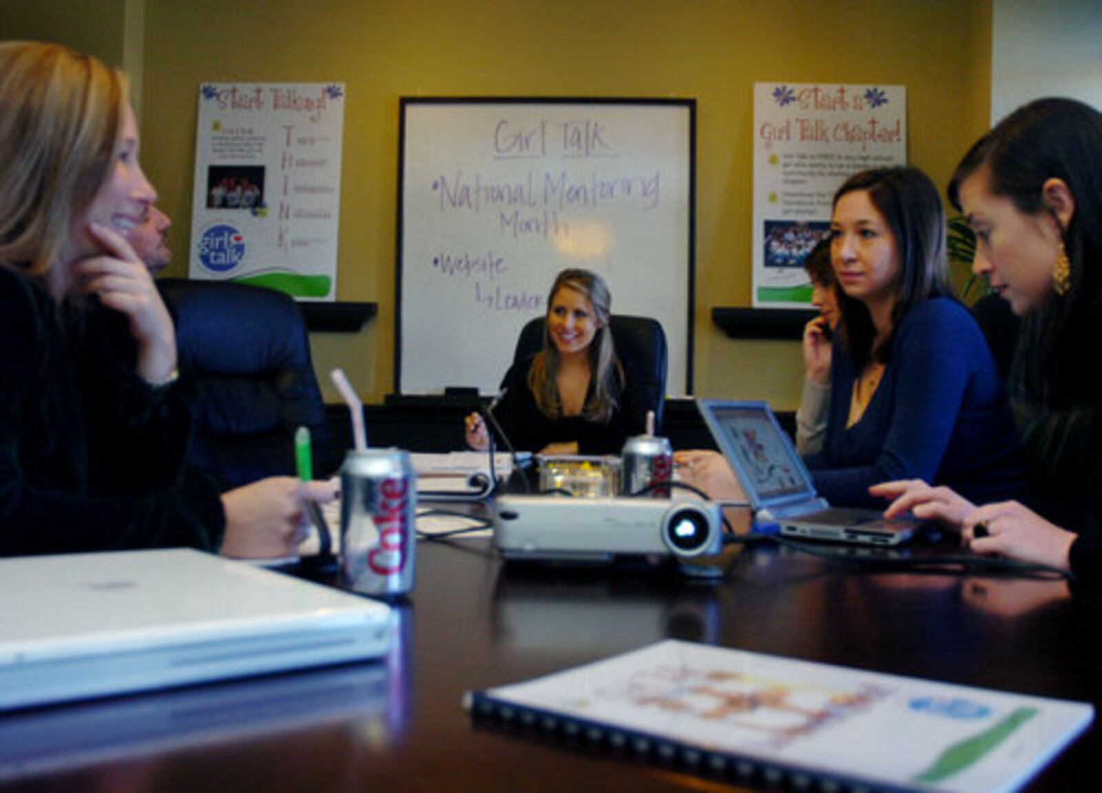 Haley Kilpatrick keeps her positive spirit flowing even in meetings with co-workers. Others, left to right: Kitsy Rose, Girl Talk PR; Doug Brown, behind Rose, founder of Brown Bag Marketing; Mary Brenna O'Neil, Girl Talk PR; Lindsey Fickel, account executive with Brown Bag Marketing; and Ginny Gilbert, an account executive with Brown Bag Marketing who handles Haley's account.