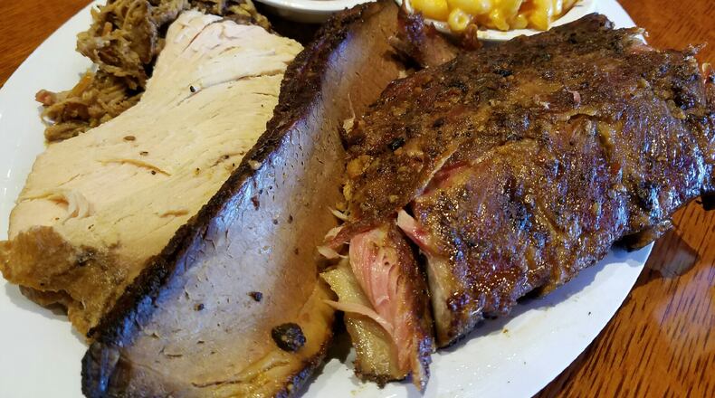The four-meats combo dinner at Company 7 BBQ in Englewood. Options include pork, brisket, sausage, turkey, rib meat, chicken or meatloaf. The four-meat meal is $25. There is a $2 up charge for each rib meat. Photo: Will Grilliot/Company 7 BBQ